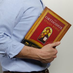 man holding the orthodox study bible