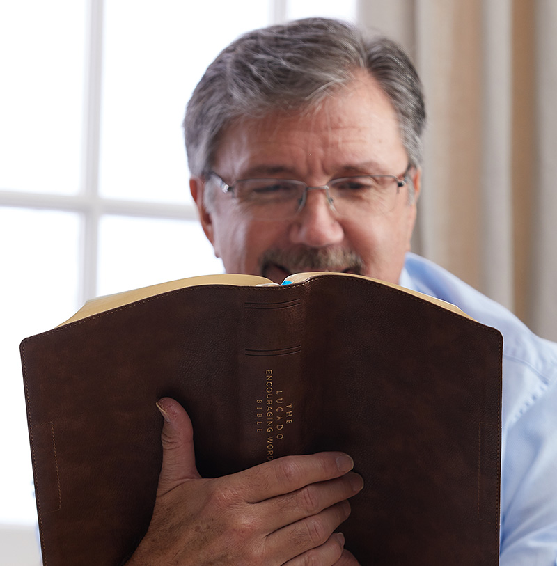 man reading Lucado Encouraging Word Bible